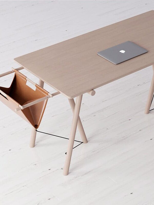 Minimalist wooden desk with a laptop and attached leather storage hammock.